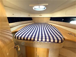 2006 Cranchi Smeraldo 37 cabin with checkered bed and porthole.