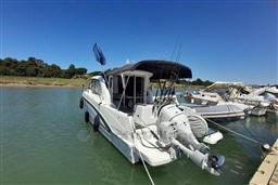 2022 Beneteau Antares 8 Fishing boat docked, equipped with fishing gear.