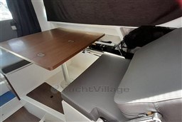 Interior of 2022 Beneteau Antares 8 Fishing boat with table and seating.