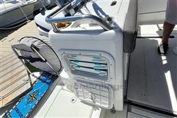 2022 Beneteau Antares 8 Fishing boat interior with storage compartments and dock view.