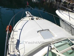 2009 Carolina Classic 28 boat deck with railing and hatch, docked in calm water.