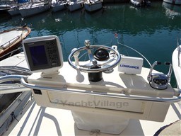 Helm of 2009 Carolina Classic 28 boat with navigation equipment and steering wheel.
