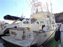 2009 Carolina Classic 28 boat docked at marina, featuring fishing equipment and spacious deck.