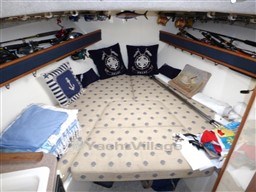 2009 Carolina Classic 28 cabin interior with nautical decor and fishing gear.