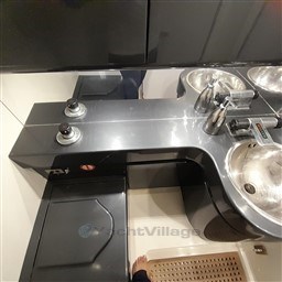 Luxury yacht bathroom with sleek metallic fixtures, Tecnomar Benetti 50 Offshore, 1989 model.