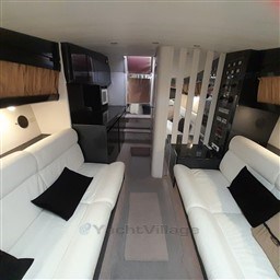 Interior of 1989 Tecnomar Benetti 50 offshore yacht with white sofas and modern design.