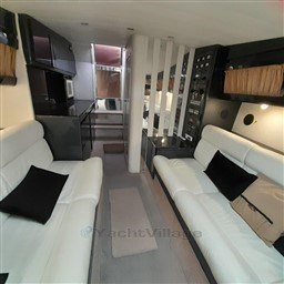 Interior of 1989 Tecnomar Benetti 50 offshore yacht with modern seating and control panels.