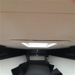 Interior cabin of 1989 Tecnomar Benetti 50 offshore yacht, featuring a skylight and cushions.