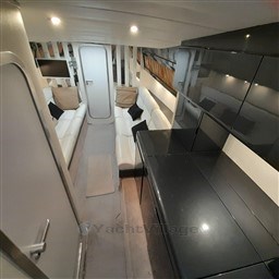 Luxurious interior of 1989 Tecnomar Benetti 50 offshore yacht with modern seating and sleek design.