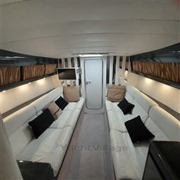 Luxurious interior of 1989 Tecnomar Benetti 50 offshore yacht with white seating and modern decor.