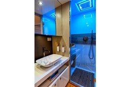 Manufacturer Provided Image: Luxurious bathroom in 2025 SACS Rebel 55 OB yacht with modern sink and illuminated shower.