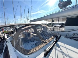 Jeanneau 53 sailboat, 2011 model, docked in marina under clear blue sky.