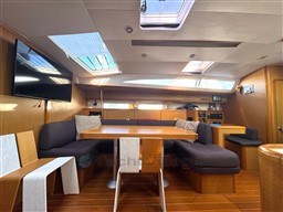 Interior of 2011 Jeanneau 53 yacht with modern seating and skylights.