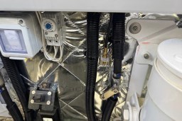 Engine compartment of 2023 Invictus TT 420 with wiring and components.