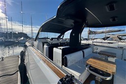 2023 Invictus TT 420 yacht interior with sleek design, docked at marina under clear sky.