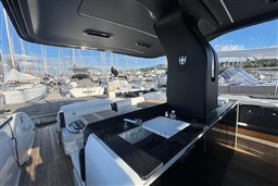 Luxurious 2023 Invictus TT 420 yacht interior with sleek design and marina view.