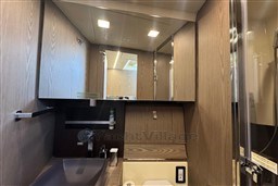 Luxurious bathroom interior of 2023 Invictus TT 420 yacht with modern fixtures and wood finish.