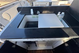 Luxury yacht Invictus TT 420 kitchen sink area with black countertop, 2023 model.