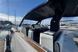 2023 Invictus TT 420 yacht interior, docked at marina with clear sky.