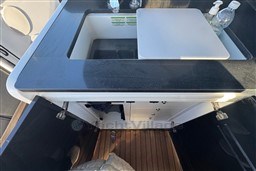 2023 Invictus TT 420 yacht kitchenette with sink, countertop, and storage cabinets.
