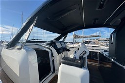 2023 Invictus TT 420 yacht cockpit with modern controls and sleek design.