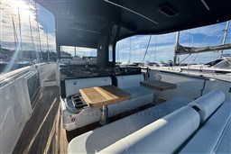 2023 Invictus TT 420 yacht interior with seating and tables, docked at marina.