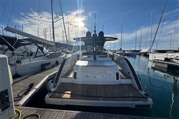 2023 Invictus TT 420 yacht docked in a sunny marina setting.