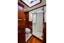 Luxurious bathroom on 1978 Stain 70 Gulet yacht with wooden finish and modern shower.