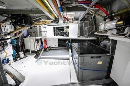 Engine room of 1978 Stain 70 Gulet, featuring mechanical equipment and storage containers.