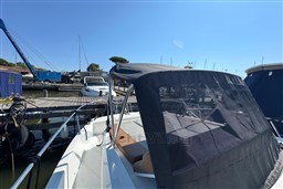 2024 Beneteau Flyer 9 SUNdeck moored at a marina under clear blue skies.