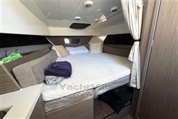 2024 Beneteau Flyer 9 SUNdeck cabin interior with cozy bed and modern design.