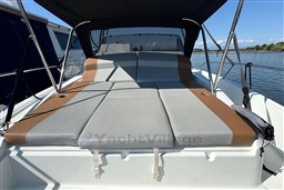 2024 Beneteau Flyer 9 SUNdeck with cushioned seating, under a canopy, on calm waters.