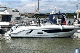 2024 Beneteau Flyer 9 SUNdeck boat docked in marina, side view.