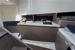 2024 Beneteau Flyer 9 SUNdeck interior with modern kitchenette and storage spaces.
