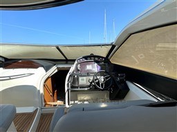 2006 Sunseeker Portofino 53 yacht cockpit with steering wheel and navigation controls.