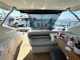 2006 Sunseeker Portofino 53 yacht interior with seating, table, and marina view.