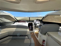 Interior view of 2006 Sunseeker Portofino 53 yacht cockpit with seating and helm.