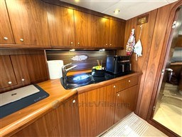 Luxurious wooden kitchen interior of 2006 Sunseeker Portofino 53 yacht.