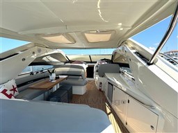 Luxurious 2006 Sunseeker Portofino 53 yacht interior with elegant seating and wooden accents.
