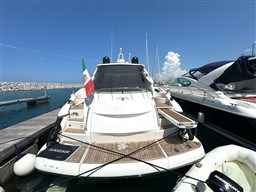 2006 Sunseeker Portofino 53 yacht docked at marina, Italian flag displayed.