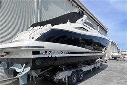 2006 Sunseeker Portofino 53 yacht on trailer, parked near industrial building.