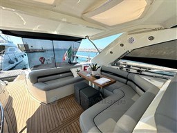 Luxurious 2006 Sunseeker Portofino 53 yacht interior with elegant seating and wooden deck.