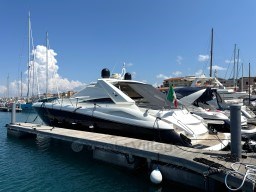 2006 Sunseeker Portofino 53 yacht docked at marina under clear blue sky.