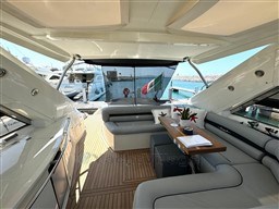 Luxurious 2006 Sunseeker Portofino 53 yacht interior with elegant seating and wooden table.