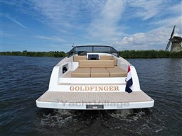 2024 VanDutch 32 Diesel boat named "Goldfinger" on water, featuring sleek design and beige seating.