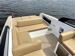 2024 VanDutch 32 Diesel yacht with beige seating, sleek design, and spacious deck on water.
