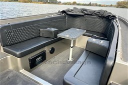 Luxurious seating area on a 2020 Seafury Hawker 725 boat with a central table.