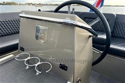 Steering console of 2020 Seafury Hawker 725 boat with cup holders and lake view.