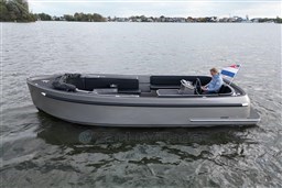 2020 Seafury Hawker 725 boat on water, with a person steering and a flag displayed.