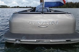 Luxury Seafury Hawker 725 boat on water, rear view with flag, 2020 model.